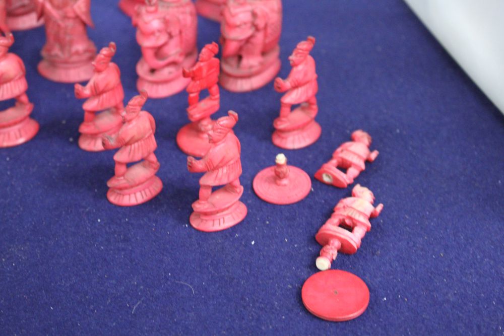 An early 20th century Chinese carved and red stained ivory chess set, carved as opposing Chinese armies, king 12cm